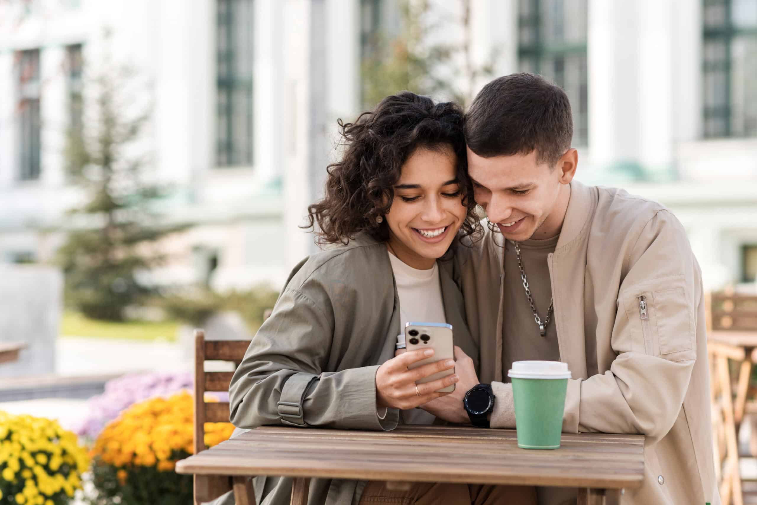 A happy couple outdoors near a cafe